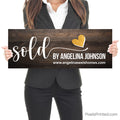 closing photo sign with homeowners sold by realtor with gold heart