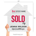 Close up of a modern house-shaped real estate sign saying Sold By in script lettering.