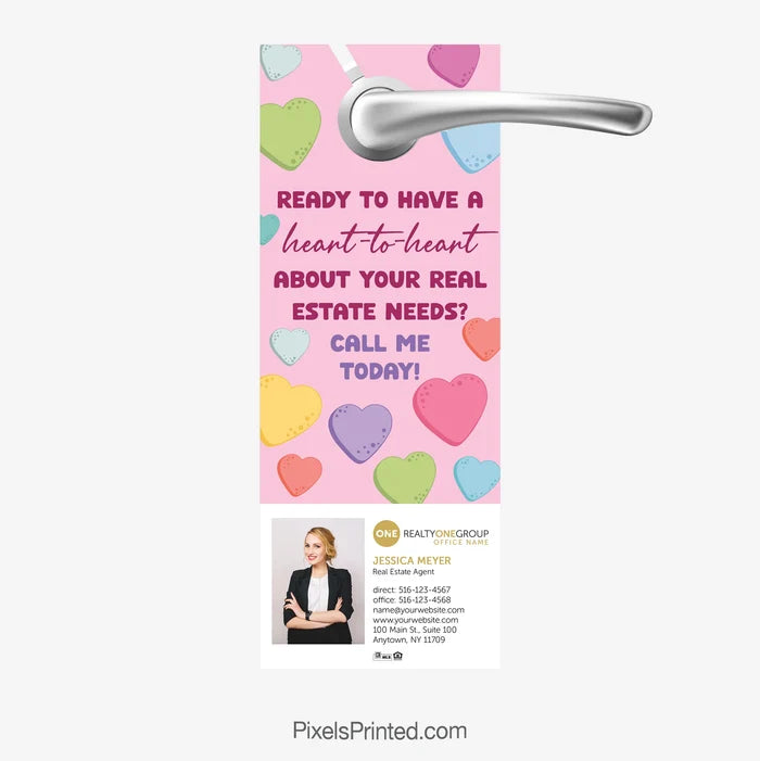Realty ONE Group Valentine-themed real estate door hanger reading “Let’s talk real estate”